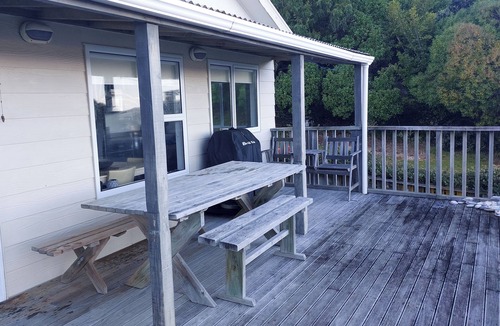 Cape Palliser House | Family friendly bach – relax on the deck and soak in the ocean views