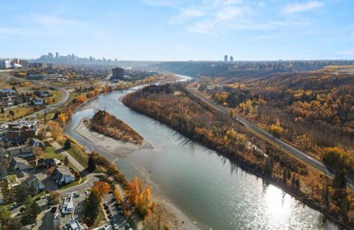 Montgomery House | Spacious 4-Bedroom Retreat Near Bow River with Foosball, Dart Board, Movie Room