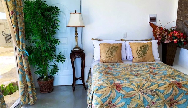 Adorable tropical room with a stunning balcony, pool, fire pit, gardens, & more!