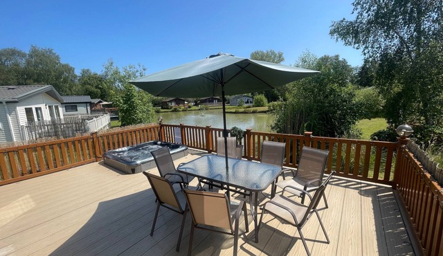 luxury lakeside lodge with a sunken hot tub on bull rush a peaceful feature lake @Tattershall lakes